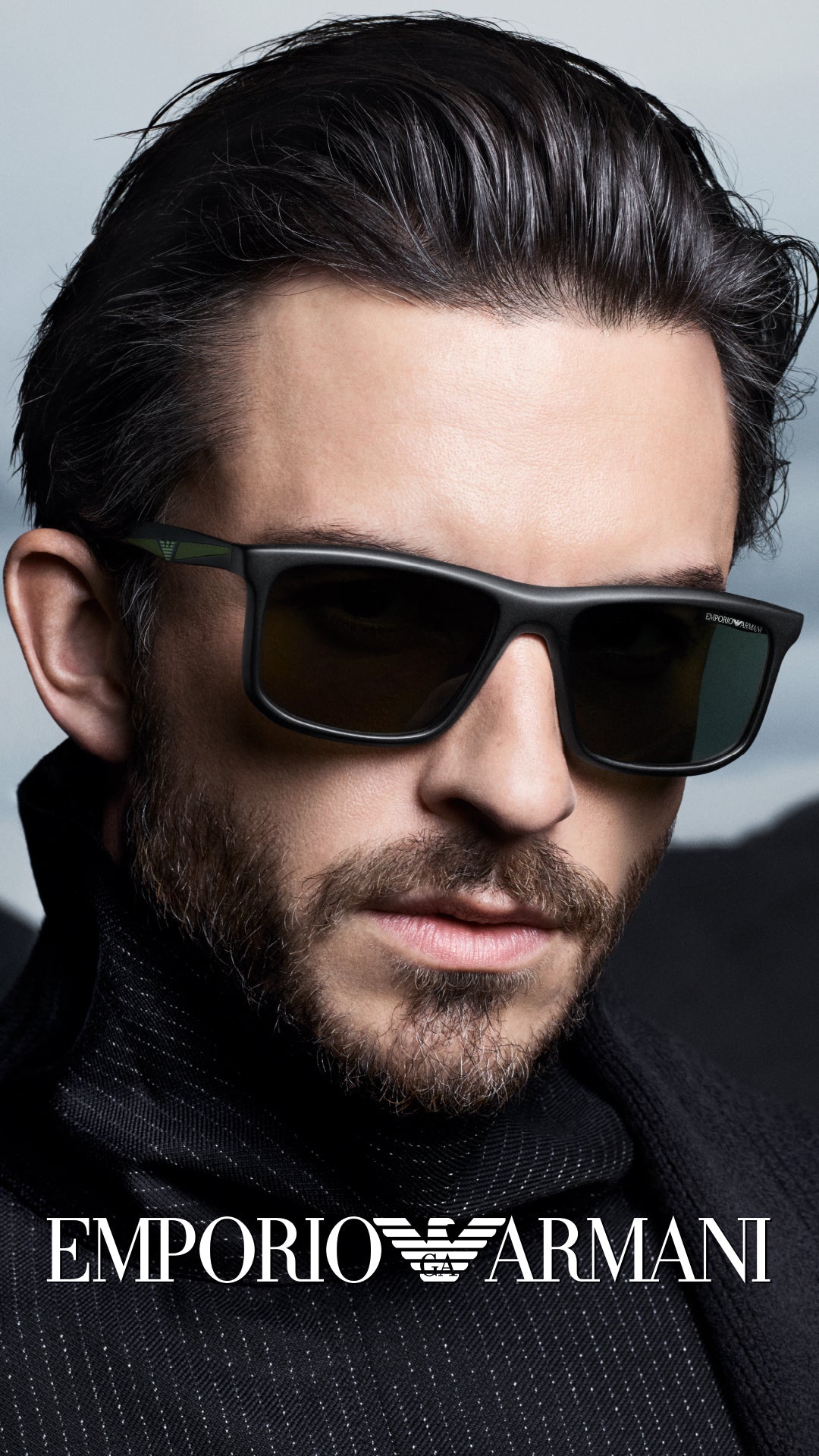 Man wearing Emporio Armani sunglasses with a blurred background